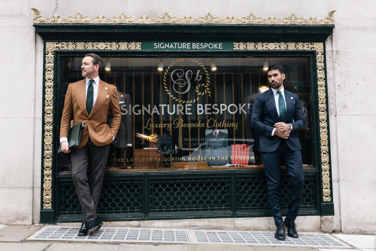 Two men wearing navy and brown bespoke tailoring